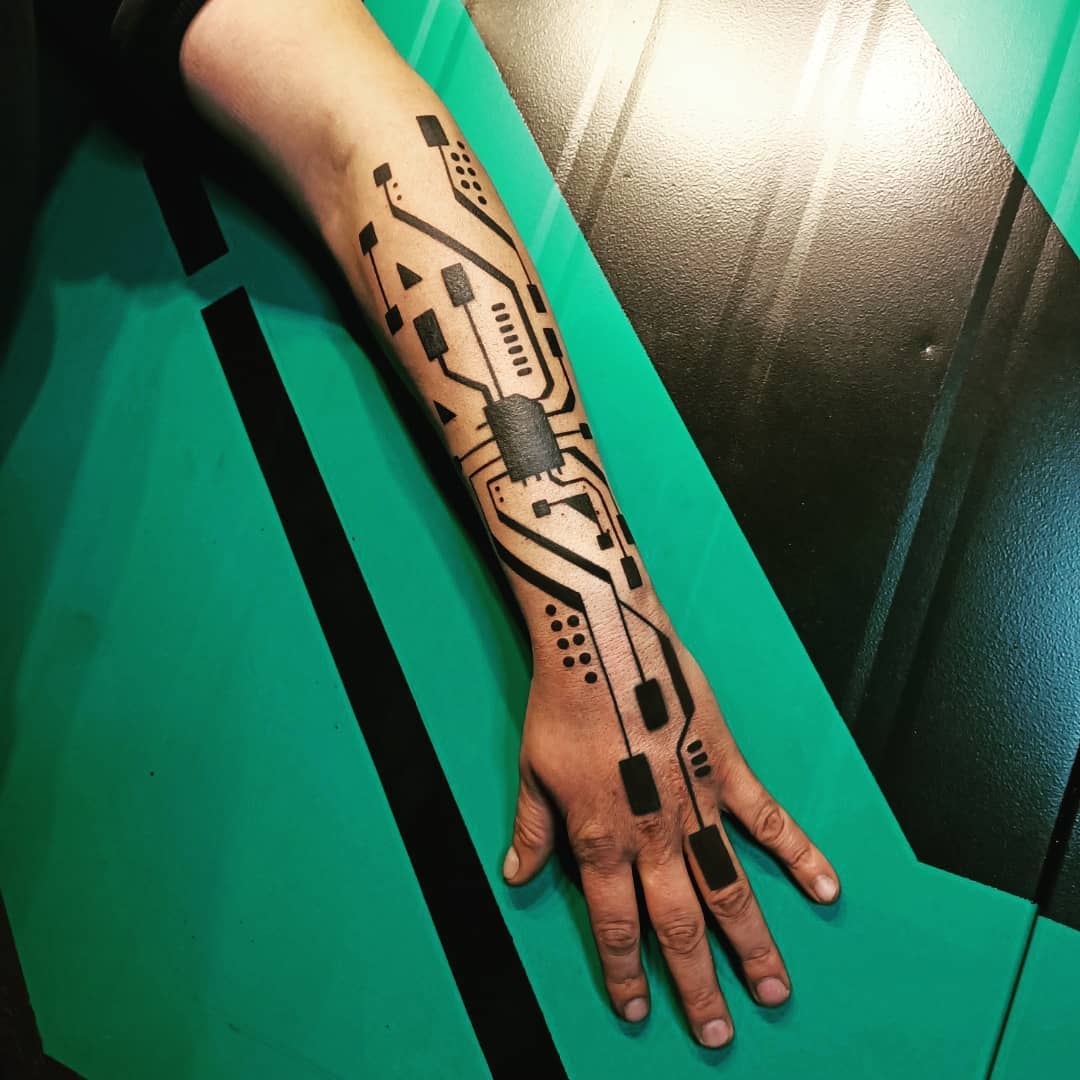 Minimalist cyberpunk tattoo on forearm, resembling a circuit board with bold black lines